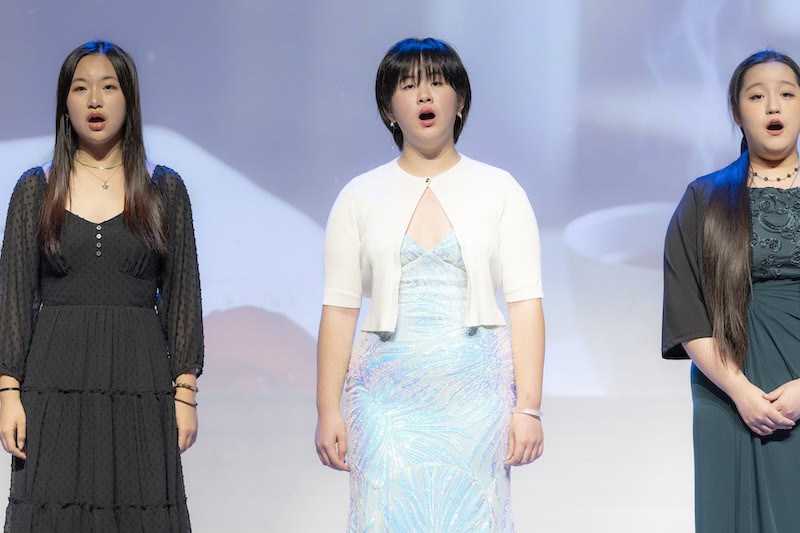 HanOpera student singing on stage in a multi-language repertoire showcase, Plano Texas concert